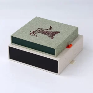 Light green linen slide drawer gift box with custom deer print and orange fabric pull tab, premium fabric wrapped packaging box for jewelry, crafts and souvenir
